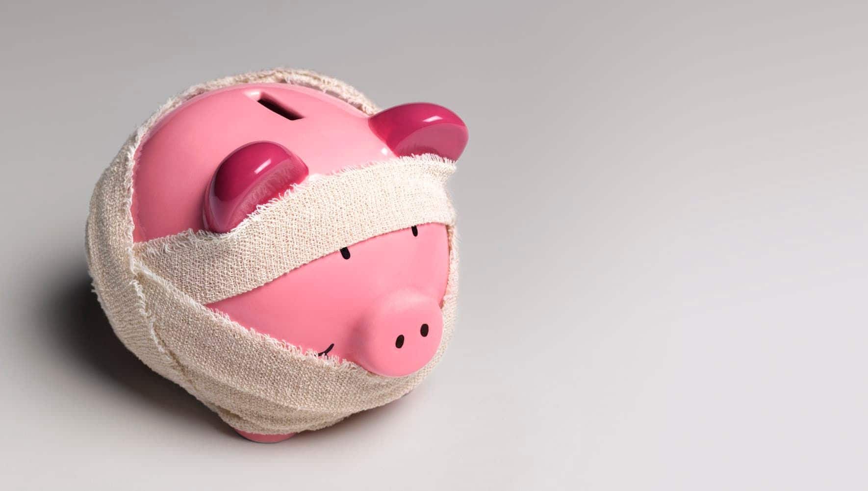 Pink piggy bank wrapped in bandages.